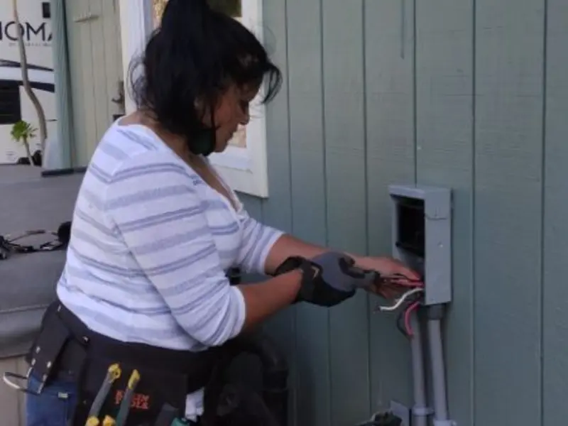 Licensed electrician wiring an exterior subpanel in Algoma